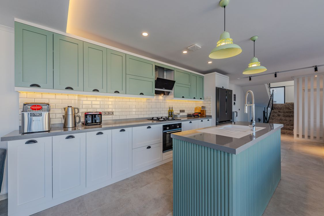 Sage green painted kitchen cabinets, a popular cabinet painting color choice for Delmar, NY homes
