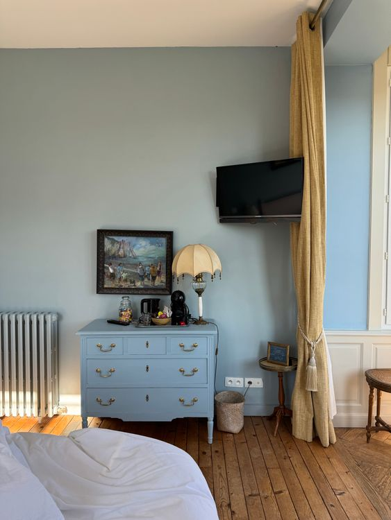 Blue painted dresser in bedroom
